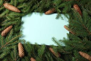 New Year's Eve background with fir branch and cones. Christmas and New Year holidays composition of pine tree branches. Happy New Year 2023 photo