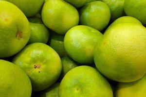 Stack of Pomelos on a market stall photo