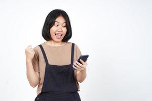 Using Smartphone with yes celebration gesture Of Beautiful Asian Woman Isolated On White Background photo