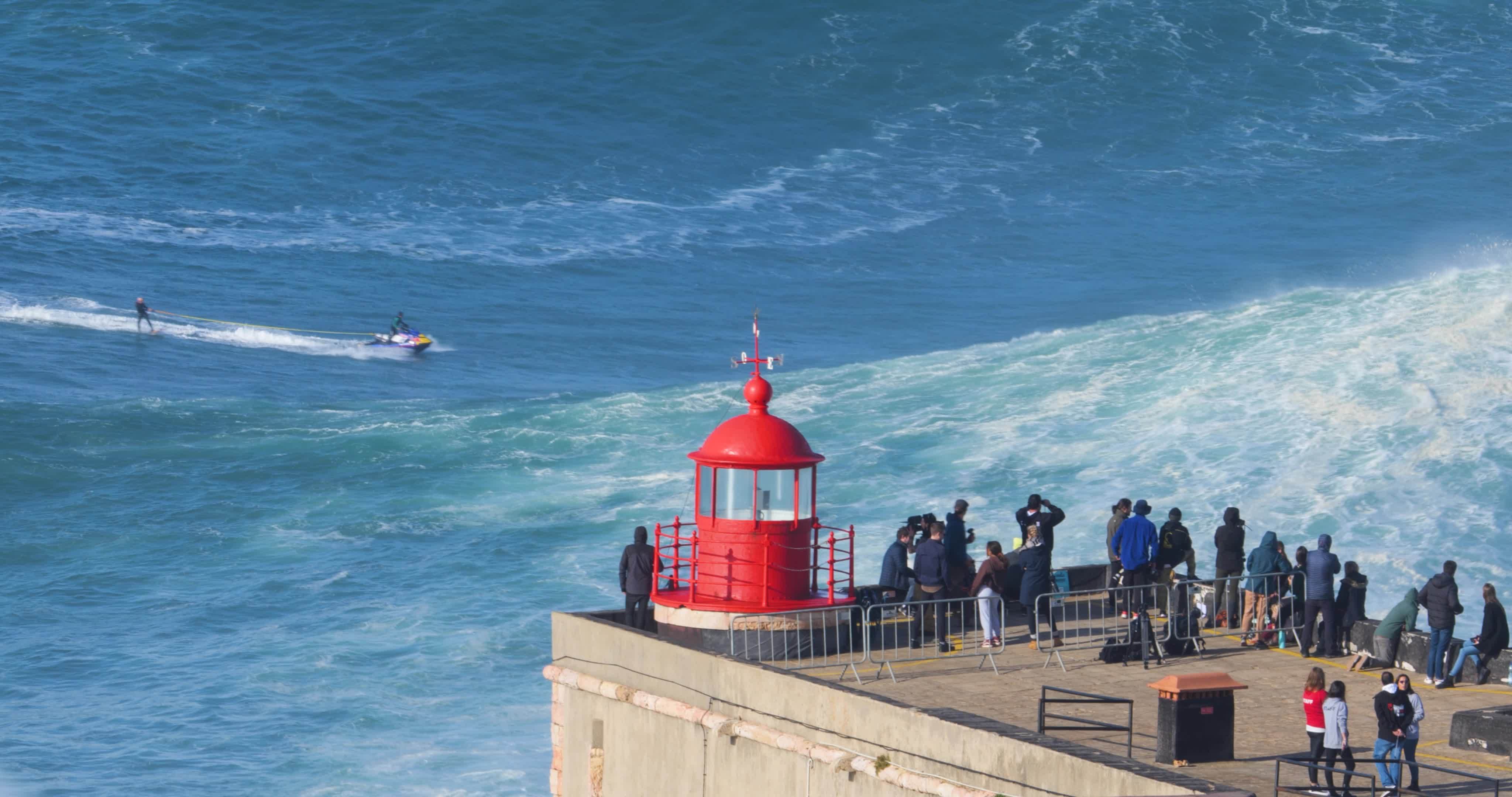 Nazare, Portugal November 7, 2022 People watching a surfer riding a