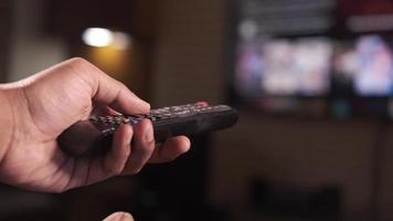 Man pushes buttons on tv remote video