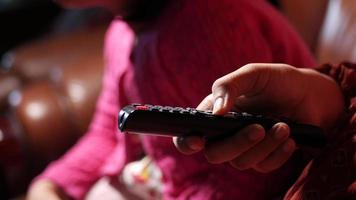 Man pushes buttons on tv remote video