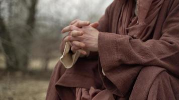 Religious Man, Jesus In Brown Robe Sitting With Folded Hands video