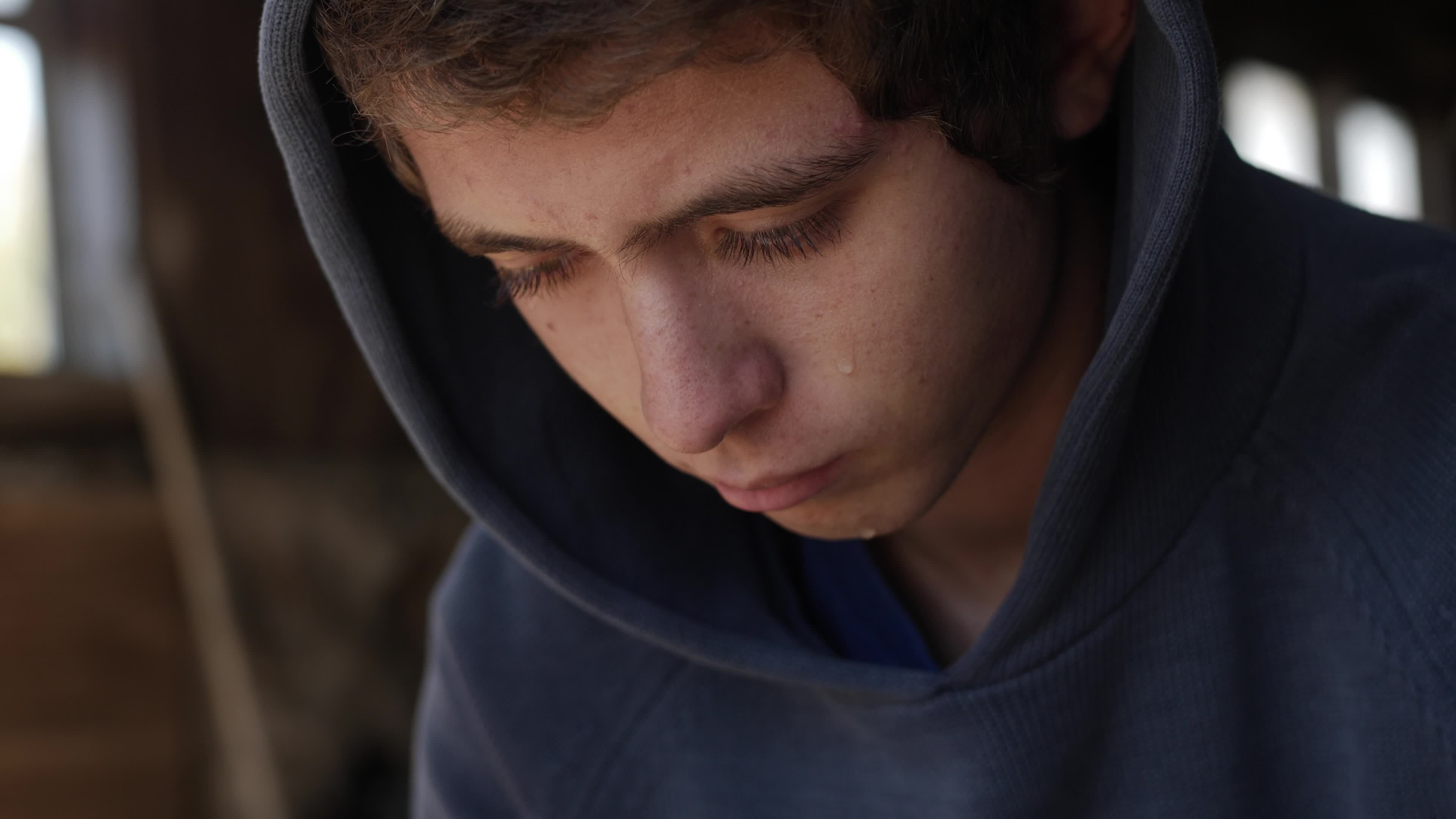Sad Young Man, Teenage Boy Sitting Alone, Crying With Tears On His Face  14432347 Stock Video at Vecteezy