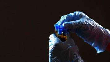 hand in blue medical gloves holding blood test tube video