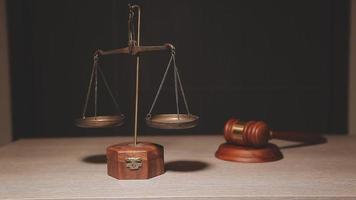 Justice and law concept.Male judge in a courtroom with the gavel, working with, computer and docking keyboard, eyeglasses, on table in morning light video