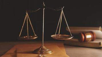 Justice and law concept.Male judge in a courtroom with the gavel, working with, computer and docking keyboard, eyeglasses, on table in morning light video