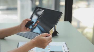 Businessman working with smart phone and laptop and digital tablet computer in office with digital marketing media in virtual icon video