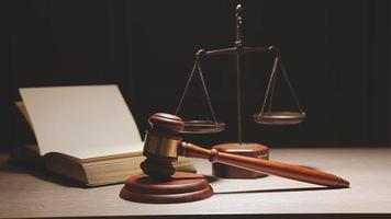 Justice and law concept.Male judge in a courtroom with the gavel, working with, computer and docking keyboard, eyeglasses, on table in morning light video