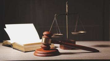 Justice and law concept.Male judge in a courtroom with the gavel, working with, computer and docking keyboard, eyeglasses, on table in morning light video