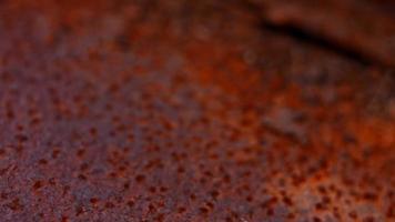 Rusty painted metal surface. Macro view of corrosion in iron metal, texture background. Smooth slow motion video