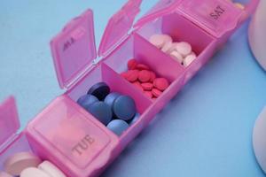 close up of medical pills in a pill box on table photo