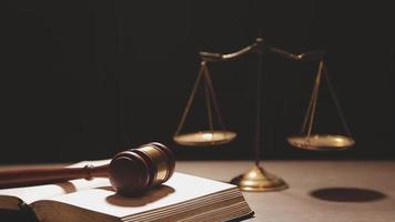 Justice and law concept.Male judge in a courtroom with the gavel, working with, computer and docking keyboard, eyeglasses, on table in morning light video