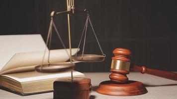 Justice and law concept.Male judge in a courtroom with the gavel, working with, computer and docking keyboard, eyeglasses, on table in morning light video