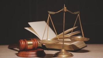 Justice and law concept.Male judge in a courtroom with the gavel, working with, computer and docking keyboard, eyeglasses, on table in morning light video