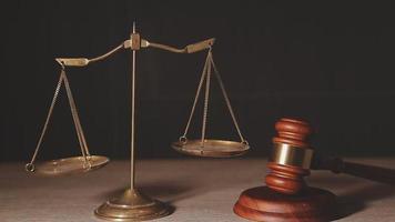 Justice and law concept.Male judge in a courtroom with the gavel, working with, computer and docking keyboard, eyeglasses, on table in morning light video