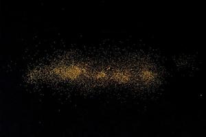 Dark texture with a sprinkling of gold. Backdrop with golden sparkle for overlay photo effect filters. fancy, luxury, themed backgrounds.
