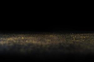 Dark texture with a sprinkling of gold. Backdrop with golden sparkle for overlay photo effect filters. fancy, luxury, themed backgrounds.