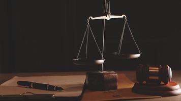 Justice and law concept.Male judge in a courtroom with the gavel, working with, computer and docking keyboard, eyeglasses, on table in morning light video