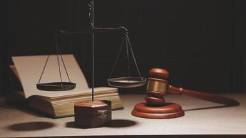 Justice and law concept.Male judge in a courtroom with the gavel, working with, computer and docking keyboard, eyeglasses, on table in morning light video