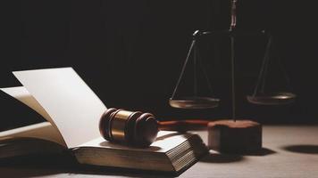 Justice and law concept.Male judge in a courtroom with the gavel, working with, computer and docking keyboard, eyeglasses, on table in morning light video