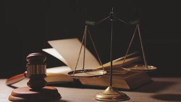 Justice and law concept.Male judge in a courtroom with the gavel, working with, computer and docking keyboard, eyeglasses, on table in morning light video