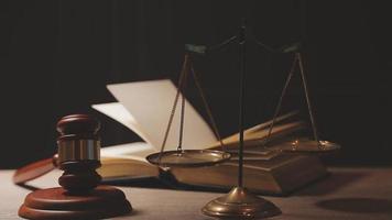 Justice and law concept.Male judge in a courtroom with the gavel, working with, computer and docking keyboard, eyeglasses, on table in morning light video