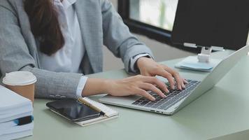 Businesswoman working with smart phone and laptop and digital tablet computer in office with digital marketing media in virtual icon video