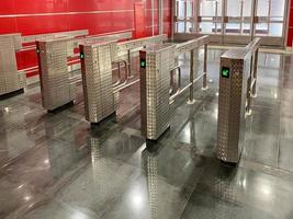 Beautiful new shiny metal automatic turnstiles for entering the subway or exiting the building photo