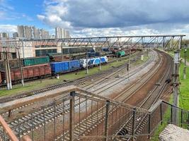 Top view of different railway wagons and tanks on an industrial railroad with rails for the transport of goods and improved modern logistics photo