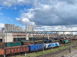 Aerial view of the Minsk-Sortirovochny railway yard with freight rail wagons. Cargo trains with goods on railroad. Freight train with petroleum tank cars and shipping containers. Soft focus photo