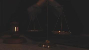 Business and lawyers discussing contract papers with brass scale on desk in office. Law, legal services, advice, justice and law concept picture with film grain effect video