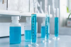 Analysis of the quality of liquids in a chemical laboratory, a device with equipment made of glass with a blue liquid photo