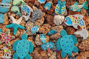 Blue ceramic toys from the evil eye in the form of different animal corals. photo