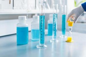 Analysis of the quality of liquids in a chemical laboratory, a device with equipment made of glass with a blue liquid photo