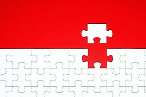 White puzzle pieces on a red background separated photo