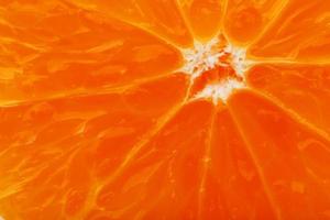 Slices of ripe orange backlit as a textural background. Full screen, close-up, macro photo