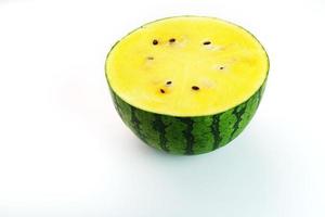 Half a juicy, yellow watermelon on a white background, texture of juicy pulp and mesmeses of ripe watermelon photo