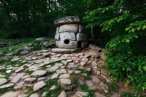 Ancient round compound dolmen in the valley of the river Jean, Monument of archeology megalithic structure. photo