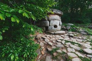 Ancient round compound dolmen in the valley of the river Jean, Monument of archeology megalithic structure. photo