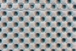 Texture of polyethylene a gray travel mat. Patterns of round dimples and rises photo