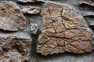 Textural background of cracked stone of an old castle. As a solid background