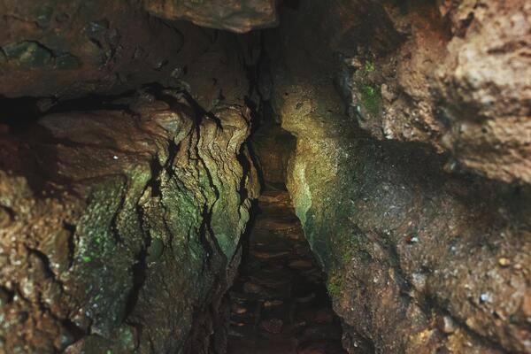 Underground Cave Stock Photos - A Long Tunnel Entrance To The Cave Underground Labyrinths Photo