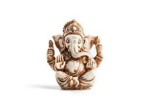 Hindu god Ganesh on a black background. Statue with incense smoke aromo sticks photo