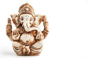 Hindu god Ganesh on a black background. Statue with incense smoke aromo sticks photo