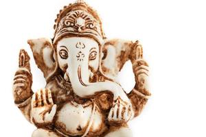 dios hindú ganesh sobre un fondo negro. estatua con incienso humo aromo palos foto