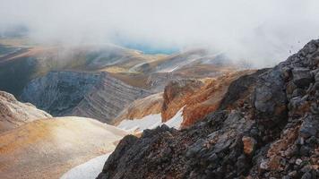 Route through mountain peaks and hills through majestic landscapes. Active tourists, hiking photo