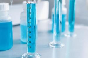 Analysis of the quality of liquids in a chemical laboratory, a device with equipment made of glass with a blue liquid photo