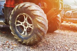 ATV in the forest, in the mud. Wheels and ATV elements close-up in the mud. Active leisure, sports and tourism. photo
