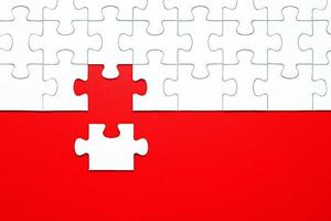 White puzzle pieces on a red background separated photo